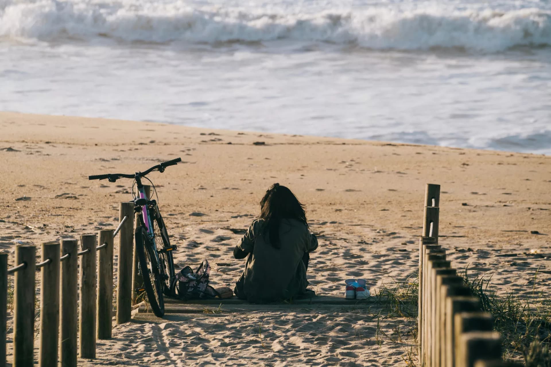 Woman on beach with bike