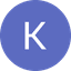 White capital letter K inside a solid periwinkle blue circle on a black background.