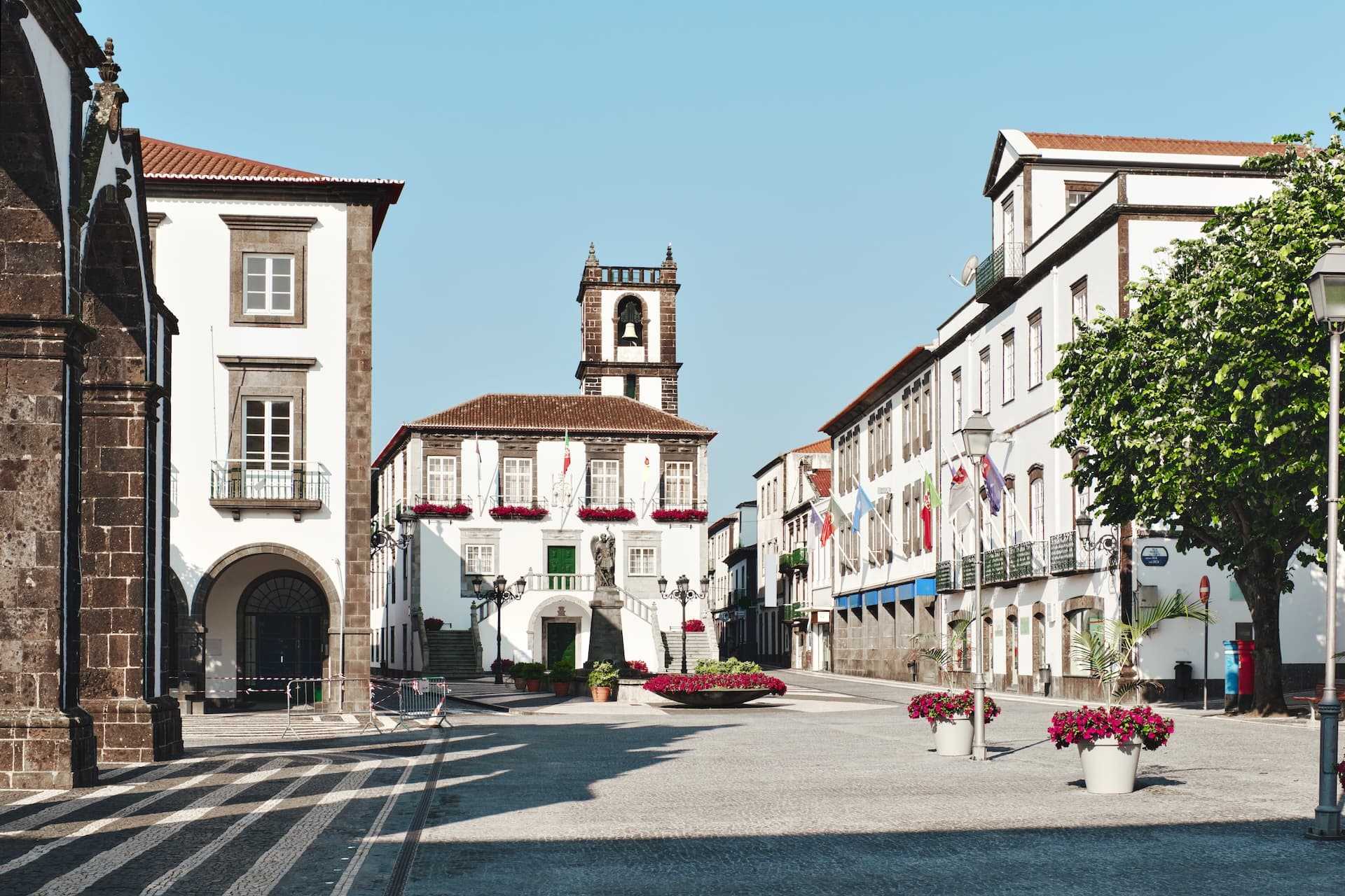 The Main Square of Ponta Delgada with white buildings and a central bell tower.